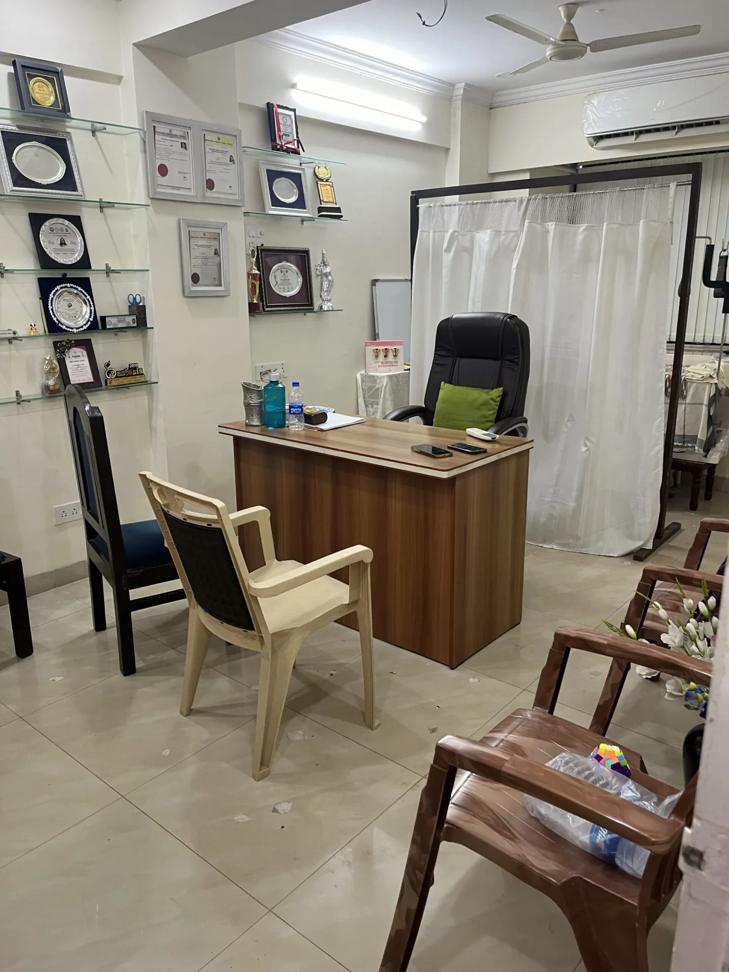 A finished hospital consulting room with examination bay and accreditation certificates