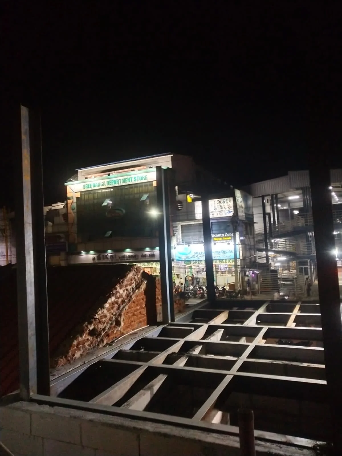 Steel floor framing under construction on site at night