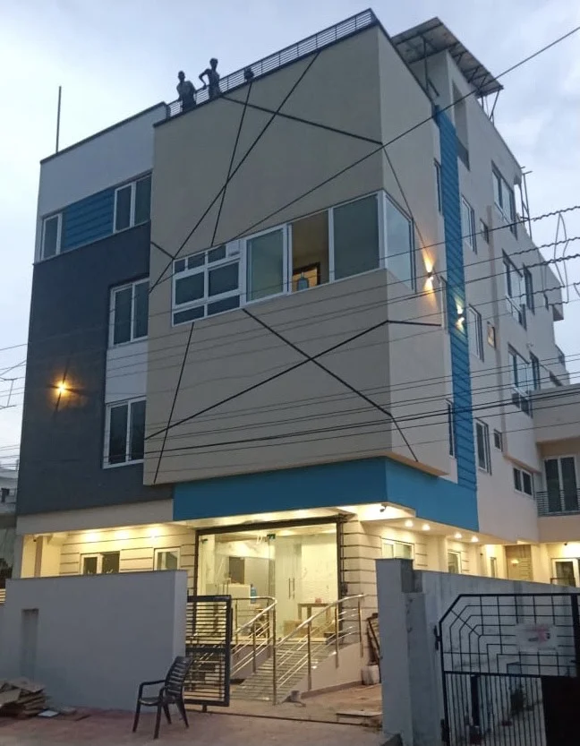 Completed multi-storey hospital building lit at dusk