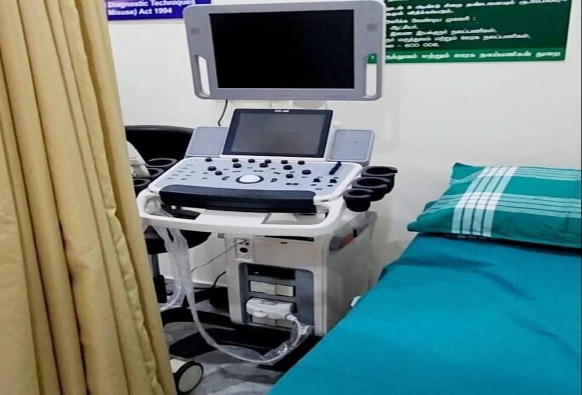 Ultrasound scanning room with colour Doppler machine, couch and PNDT notice