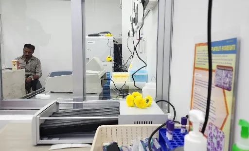 Sample collection counter viewed through a glass partition